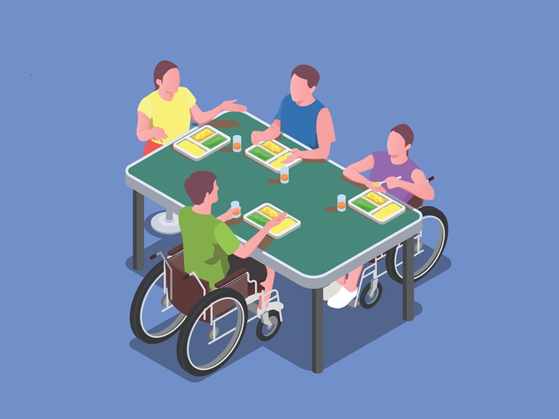 IT training session for persons with disabilities — instructor guiding students at computers